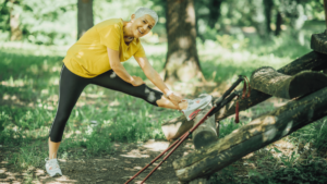 Blog header photo for Wellness Action Item: Exercise. Photo depicts a person stretching outside in preparation to exercise.