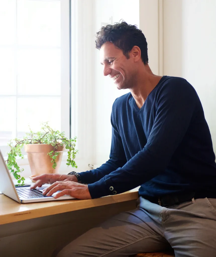 man smiling using laptop