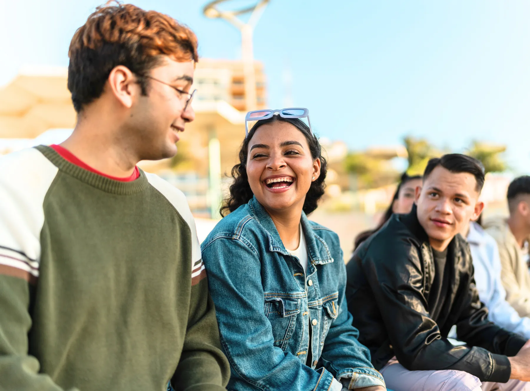 Group of younger adults smiling and laughing together