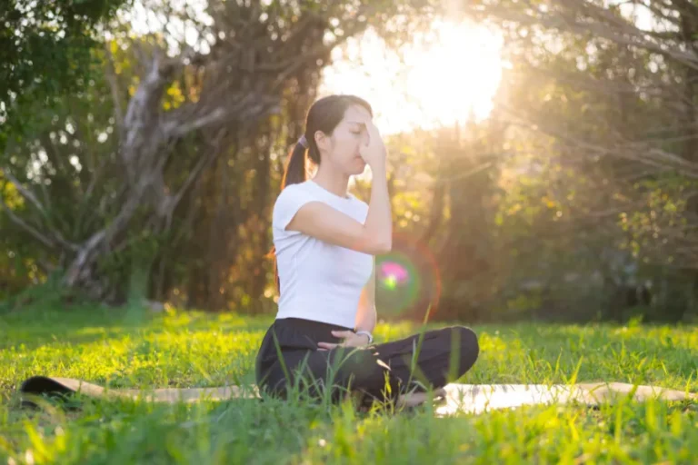 Woman sitting crosslegged outdoors
