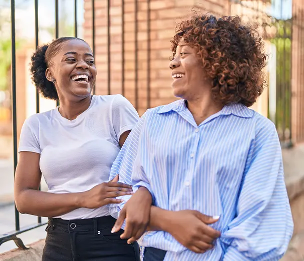 african american women mother daughter standing together in the street