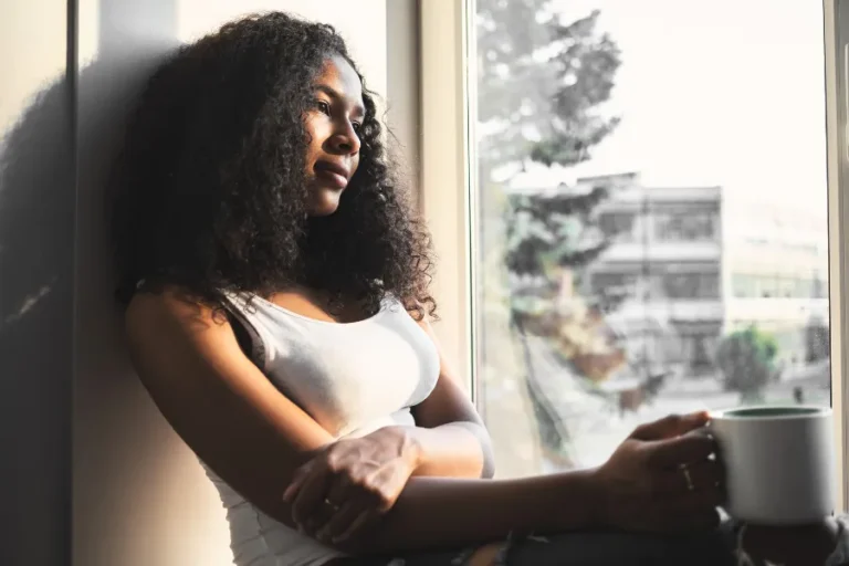 Woman looking out her window
